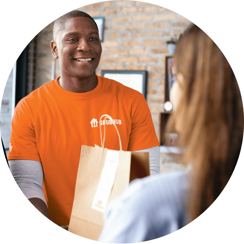 Grubhub delivery driver picking up an order from a restaurant